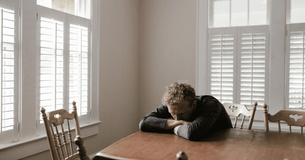 image - San Jose Mental Health Adderall for depression: Man rests head on table, illustrating Adderall's role in managing depression symptoms.