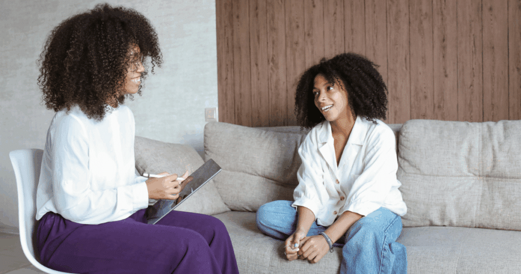 image - San Jose Mental Health Psychiatrist consultation: Woman in therapy session discussing medication management with healthcare professional.