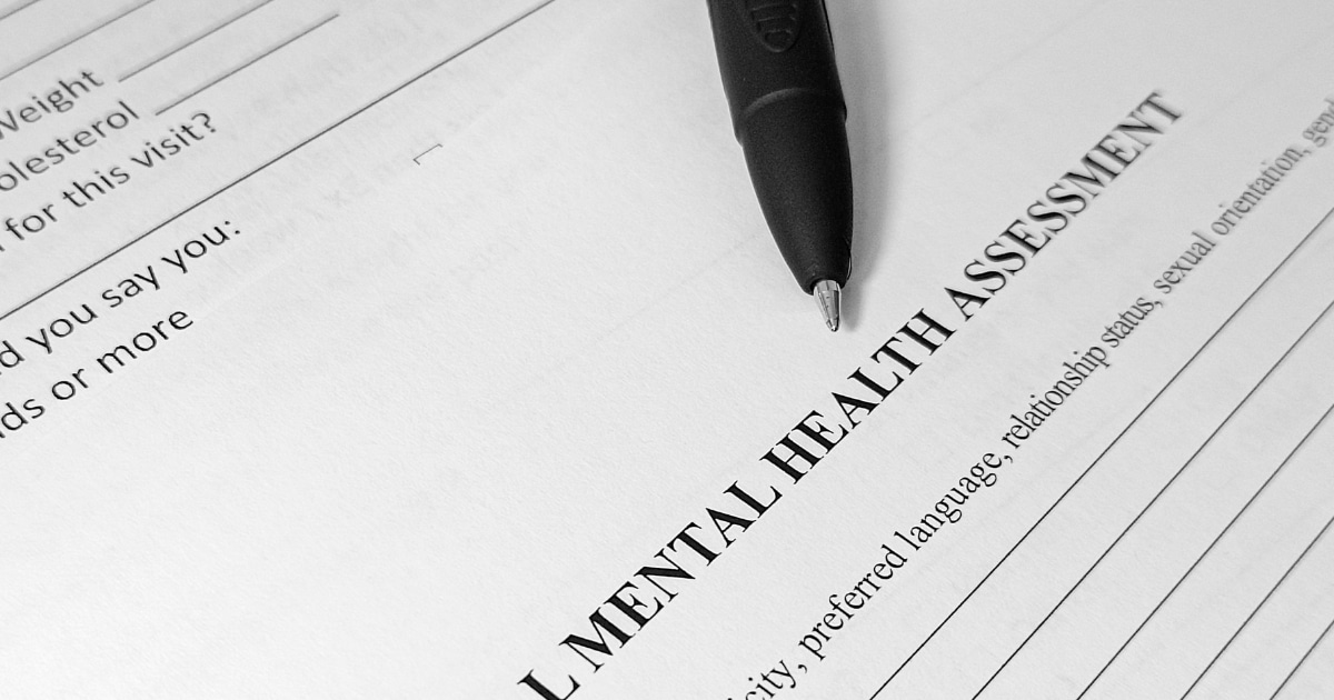 IMAGE - 2026-09-04T234736977 - San Jose Mental Health Pen resting on a document labeled 'Mental Health Assessment,' angled across the page